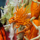 Young girl looks at radish carved in the shape of a dragon